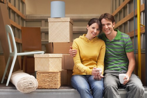 Professional movers handling desks and technology during an office move
