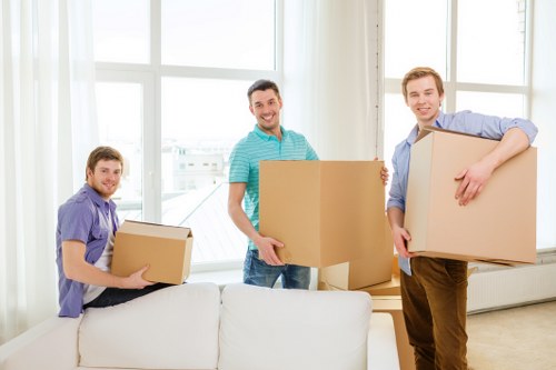 Boxes and furniture being loaded into a removals van for an urgent move