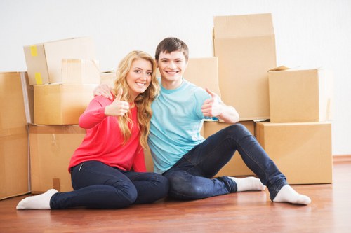 Specialist piano movers protecting floors and walls during a move