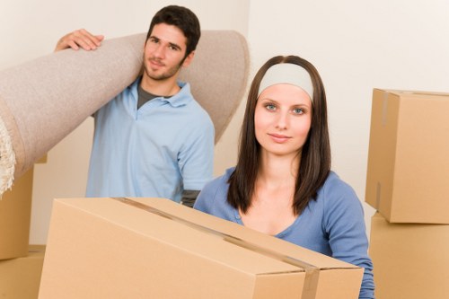 Movers carrying boxes through a Stockwell property during a quick relocation